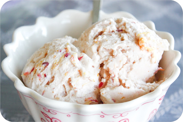 Delicious homemade fruit ice cream with fresh fruit pieces in a white bowl.