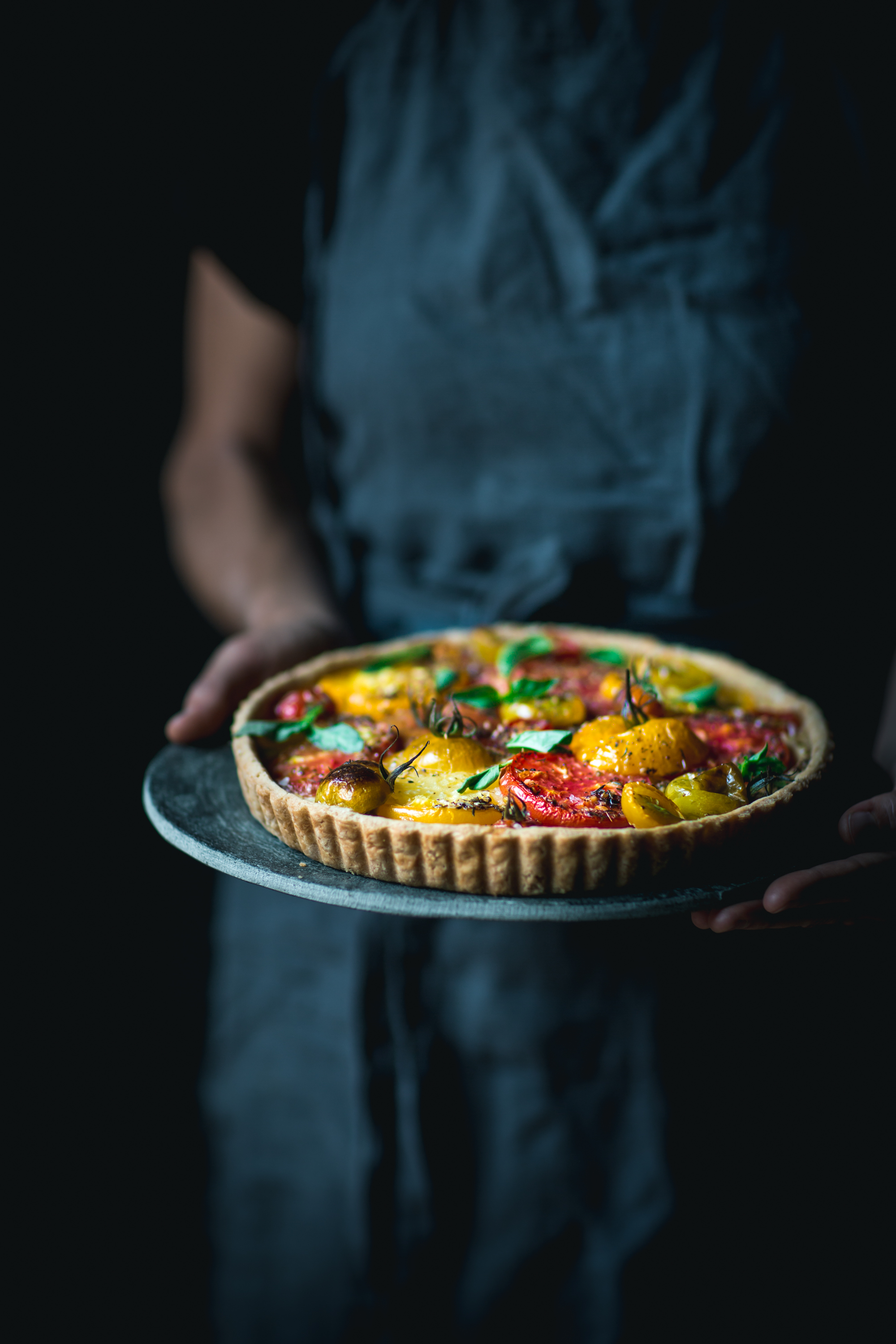 The best and easiest heirloom tomato tart recipe, with ricotta, balsamic caramelized onions, fresh basil, and a buttery tart crust.