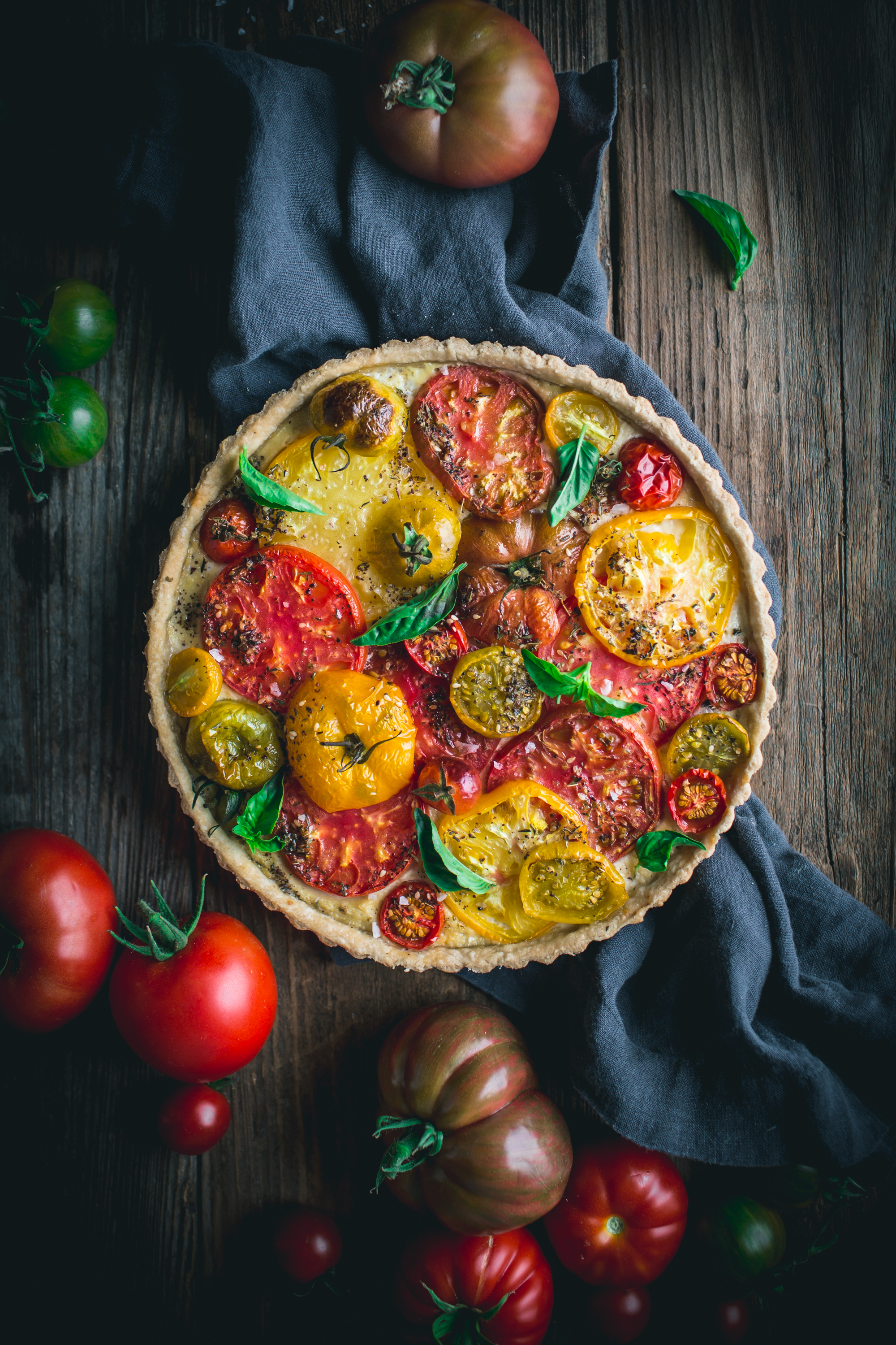 The best and easiest heirloom tomato tart recipe, with ricotta, balsamic caramelized onions, fresh basil, and a buttery tart crust.