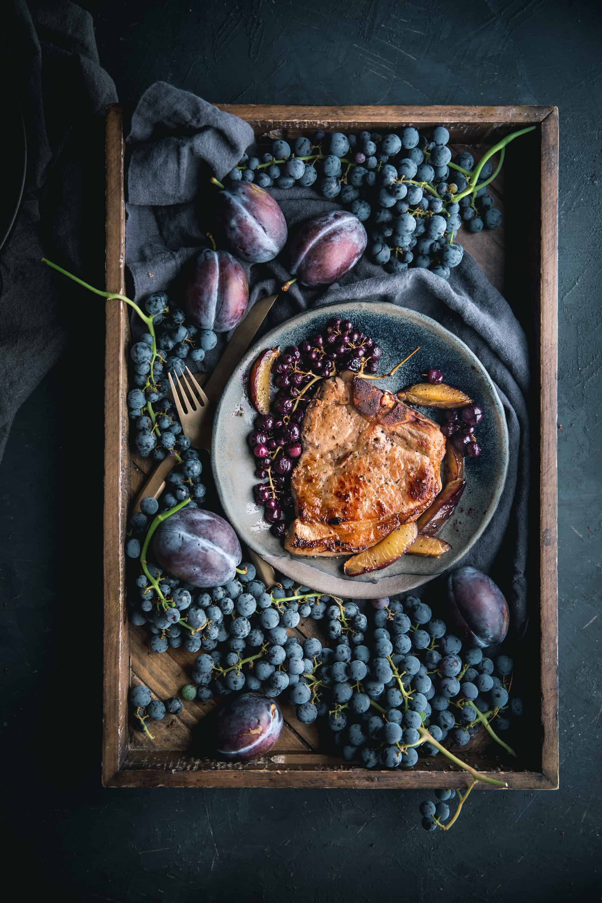 Perfect Brined Bone In Pork Chop with Roasted Grapes and Plums by Eva Kosmas Flores